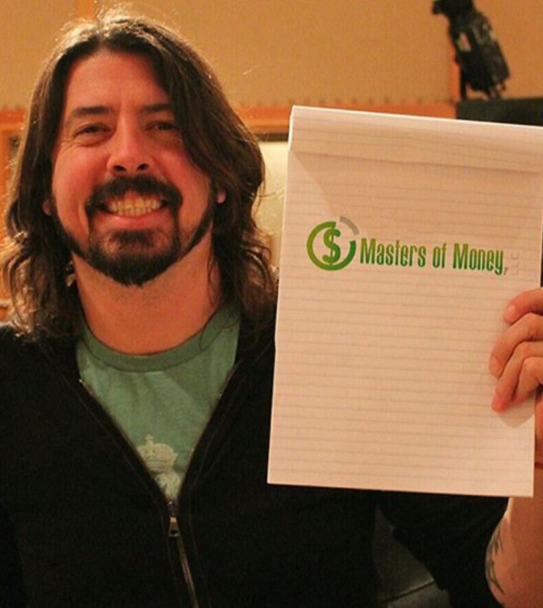 Dave Grohl Holding a Masters of Money Logo Sign Photo